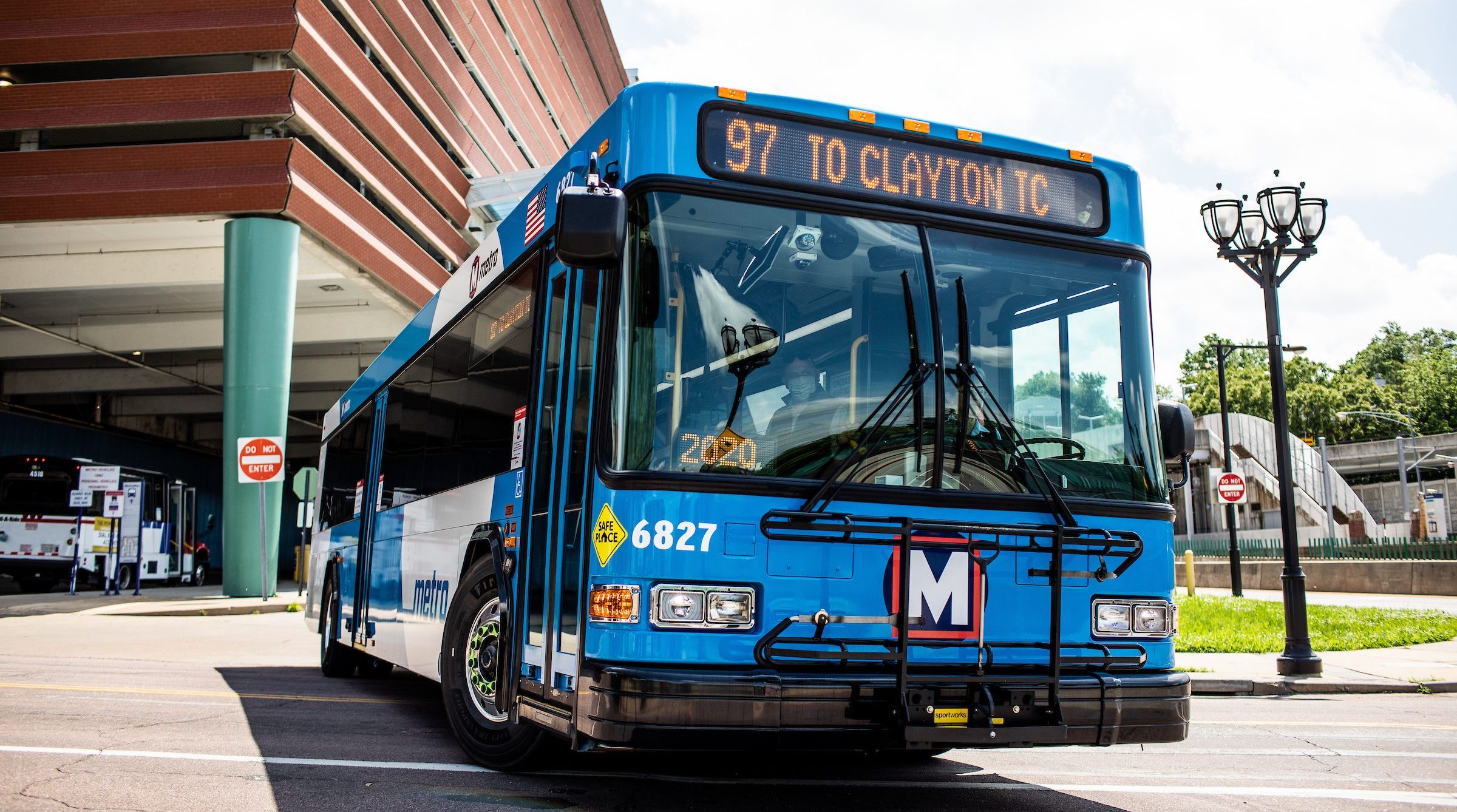 A MetroBus pulls out of the Clayton transit center. The operator can be seen through the windshield.