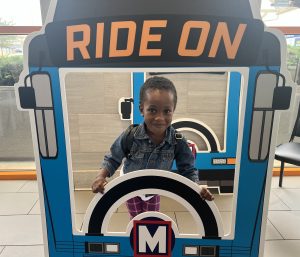 Young rider Emmanuelle holding a Ride On sign