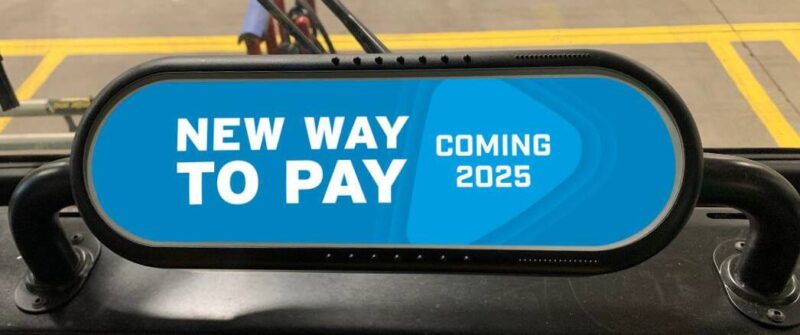 A fare validation device on a bus, showing a screen with text: NEW WAY TO PAY, COMING 2025