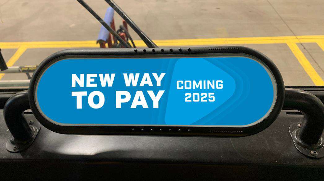 A fare validation device on a bus, showing a screen with text: NEW WAY TO PAY, COMING 2025