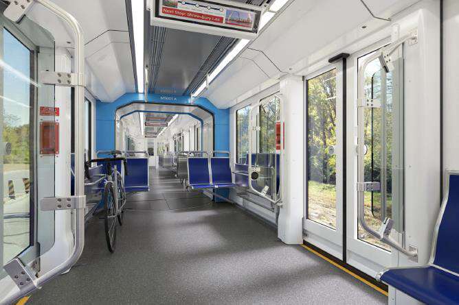 View of the inside of a next-generation MetroLink vehicle concept, featuring a spacious interior and large glass windows throughout the train