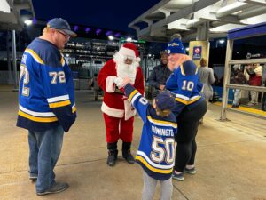 Blues fans greet Santa at the Civic Center Station.