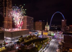 Photo of fireworks going off at celebration in downtown St. Louis with the Gateway Arch in the background