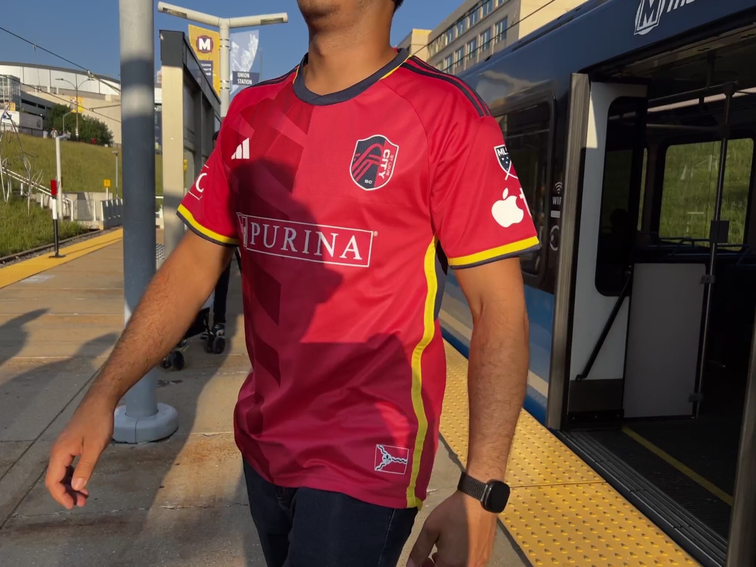 City SC fan walking off a MetroLink train