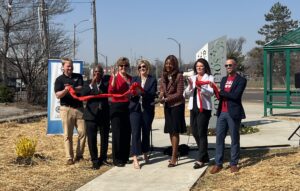 Photo of Mayor Tishaura Jones, Kim Cella, Charles Stewart and others at a ribbon cutting for a updated bus stop in Soulard